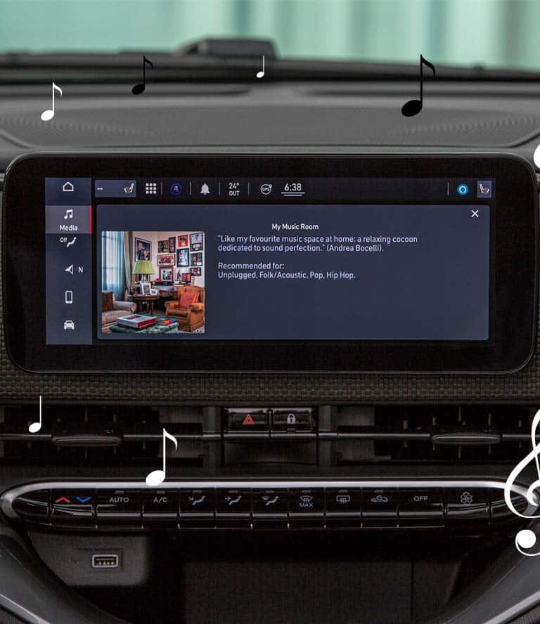 The Uconnect touchscreen in the 2024 Fiat 500e Inspired By Los Angeles displaying the JBL Virtual Venue: My Music Room by Andrea Bocelli, with animated black and white musical notes scattered about.